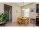 Eat-in kitchen with a breakfast nook that includes a wooden table with 4 chairs, a window, and access to other rooms at 1000 Seburn Rd, Apopka, FL 32703