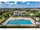 Community pool with ample seating space, surrounded by lush landscaping and palm trees at 1000 Seburn Rd, Apopka, FL 32703