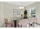 Elegant dining room featuring a modern glass table, stylish chairs, and a decorative chandelier at 1000 Seburn Rd, Apopka, FL 32703