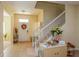 Inviting entryway with staircase, tile floors, and a charming front door adorned with a decorative wreath at 1000 Seburn Rd, Apopka, FL 32703