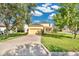 Charming yellow two-story home with a well-manicured lawn and a driveway at 1000 Seburn Rd, Apopka, FL 32703
