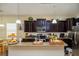 Spacious kitchen featuring dark wood cabinets, stainless steel appliances, and a granite countertop island at 1000 Seburn Rd, Apopka, FL 32703