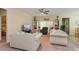 Comfortable living room with neutral tones, striped sofas, and a ceiling fan at 1000 Seburn Rd, Apopka, FL 32703