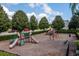 Community playground with slides, climbing structures, and swings surrounded by trees at 1000 Seburn Rd, Apopka, FL 32703