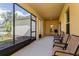 Spacious, screened porch featuring seating and view of landscaped yard at 1000 Seburn Rd, Apopka, FL 32703