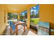 Inviting porch with a dining table, chairs, and a grill, perfect for outdoor dining at 1000 Seburn Rd, Apopka, FL 32703