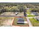 An aerial view of a new construction home on a spacious lot with a long driveway and green lawn at 110 Alta Vista Way, Davenport, FL 33837