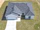 Aerial view of a single story home featuring a gray roof, a two car garage, and a well maintained lawn at 110 Alta Vista Way, Davenport, FL 33837