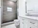 Well-lit bathroom featuring tiled shower, marble vanity top, and modern finishes at 110 Alta Vista Way, Davenport, FL 33837