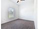 Bright bedroom with neutral carpet, ceiling fan, and large window at 110 Alta Vista Way, Davenport, FL 33837