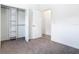 Bright bedroom with neutral carpet, walk-in closet, and a view into the next room at 110 Alta Vista Way, Davenport, FL 33837