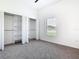 Bright bedroom with neutral carpet, closet with organizer, and natural light at 110 Alta Vista Way, Davenport, FL 33837