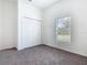 Bedroom with neutral carpet, natural light, and closet at 110 Alta Vista Way, Davenport, FL 33837