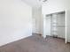 Bright bedroom with neutral carpet and a walk-in closet with organizer at 110 Alta Vista Way, Davenport, FL 33837
