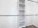 Walk-in closet featuring built-in shelving and metal hanging rods for optimal organization and storage solutions at 110 Alta Vista Way, Davenport, FL 33837