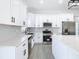 Modern kitchen with stainless steel appliances, quartz countertops, and shaker cabinets at 110 Alta Vista Way, Davenport, FL 33837