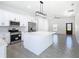 Modern kitchen with stainless steel appliances and center island opens to the living room at 110 Alta Vista Way, Davenport, FL 33837