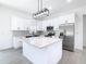 Bright and airy kitchen with stainless steel appliances, quartz countertop island at 110 Alta Vista Way, Davenport, FL 33837