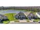 This aerial shot showcases a charming home with a pond view, perfect for serene living at 1130 Pando Loop, Orlando, FL 32824