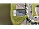 This aerial shot showcases a large, fenced backyard and paved patio with outdoor seating near a pond at 1130 Pando Loop, Orlando, FL 32824