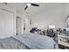 Bright bedroom with a ceiling fan, closet, and a desk area for work and study at 1130 Pando Loop, Orlando, FL 32824
