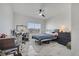 Bedroom with neutral walls, ceiling fan, and a window overlooking the residential area at 1130 Pando Loop, Orlando, FL 32824