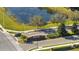 Woodland Park community entrance with mature landscaping and a tranquil pond view at 1130 Pando Loop, Orlando, FL 32824