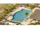 Aerial view of a community pool featuring lounge chairs and palm tree landscaping at 1130 Pando Loop, Orlando, FL 32824