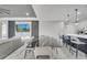 Open concept dining room with a modern black and white table, chairs and a view to the kitchen at 1130 Pando Loop, Orlando, FL 32824