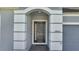 Exterior showcases an arched entrance and a dark woodgrain front door with sidelight at 1130 Pando Loop, Orlando, FL 32824