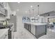 Spacious open kitchen with a large island with seating, stainless steel appliances, and modern finishes at 1130 Pando Loop, Orlando, FL 32824