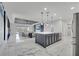 Open-concept kitchen and living area showcases modern lighting fixtures and access to an outdoor area at 1130 Pando Loop, Orlando, FL 32824