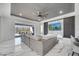 Open-concept living room with a large gray sectional sofa and an adjacent patio area at 1130 Pando Loop, Orlando, FL 32824
