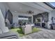 Outdoor living space with comfortable seating area, outdoor kitchen, TV and lake views, perfect for entertaining at 1130 Pando Loop, Orlando, FL 32824