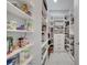 Walk-in pantry with ample shelving, drawers, and storage space for all your culinary needs at 1130 Pando Loop, Orlando, FL 32824