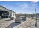 Beautiful outdoor patio featuring comfortable seating, an outdoor kitchen, and serene lake views at 1130 Pando Loop, Orlando, FL 32824