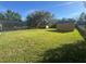 Large backyard with shed and screened in pool area, and lush green lawn at 1201 Providence Blvd, Kissimmee, FL 34744