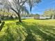 View of backyard with trees, lawn, shed, trampoline, and white picket fence at 1201 Providence Blvd, Kissimmee, FL 34744