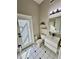 Bright bathroom with a modern vanity, toilet, and black-and-white checkered floor at 1201 Providence Blvd, Kissimmee, FL 34744