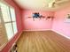 Bright bedroom features light wood flooring and a large window with white shutters at 1201 Providence Blvd, Kissimmee, FL 34744