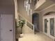 Elegant foyer showcasing a modern chandelier, staircase, and double doors at 1201 Providence Blvd, Kissimmee, FL 34744