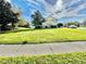 Manicured lawn in the front yard of a two story home with white trim and green exterior paint at 1201 Providence Blvd, Kissimmee, FL 34744