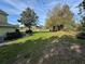 Expansive front yard with lush green grass, mature trees, and a winding walkway at 1201 Providence Blvd, Kissimmee, FL 34744