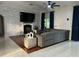 Inviting living room featuring a stone fireplace, a large TV, and comfortable seating at 1201 Providence Blvd, Kissimmee, FL 34744