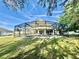 Screened in back porch and pool with lounge furniture with view of backyard at 1201 Providence Blvd, Kissimmee, FL 34744