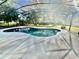 Backyard swimming pool with screened-in enclosure for outdoor enjoyment at 1201 Providence Blvd, Kissimmee, FL 34744