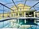 A screened-in pool area with patio furniture offers a relaxing outdoor space at 1201 Providence Blvd, Kissimmee, FL 34744