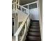 Elegant staircase with dark wood steps, glass railing, and a modern chandelier at 1201 Providence Blvd, Kissimmee, FL 34744