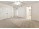 Spacious bedroom with carpet, ceiling fan, and multiple closet doors at 14463 Breakwater Way, Winter Garden, FL 34787