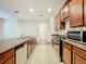 Well-lit kitchen features an island, granite countertops, stainless steel appliances, and wood cabinets at 14463 Breakwater Way, Winter Garden, FL 34787